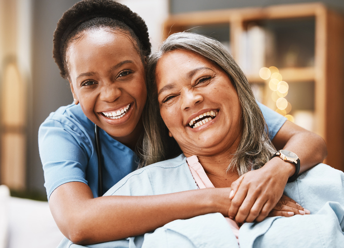 Nurse embracing a elderly woman